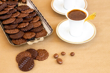 Madlen chocolate in vintage silver tray on kraft paper background with coffee.