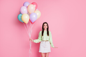 Portrait of charming pretty youth girl hold many air balloons enjoy anniversary event wear good look clothes isolated over pastel color background