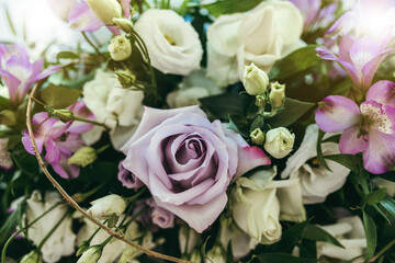 Fill the frame bridal decorations with floral bouquet. Closeup purple rose.