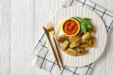 baked broccoli tots on a plate, top view