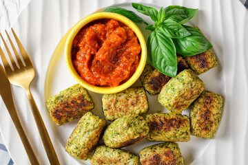 baked broccoli tots on a plate, top view