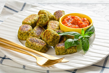 baked broccoli tots on a plate, close-up