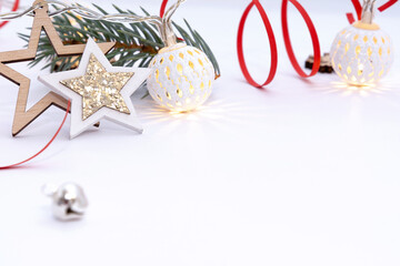 Christmas composition of wooden stars with sparkles, garlands of white luminous balls, fir branches...