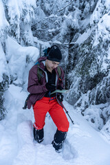 Man standing in winter mountain forest
