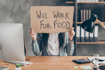 Covid economics poverty crisis concept. Despair frustrated girl need job hold cardboard text will work for food wear jacket blazer sit table desk in workplace workstation