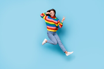Fototapeta na wymiar Full length body size view of her she nice-looking attractive lovely pretty funky cheerful cheery girl jumping having fun showing v-sign party time isolated blue pastel color background