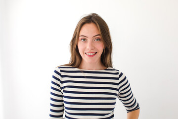 Portrait of a beautiful young woman looking at the camera and smiling, isolated on a white background