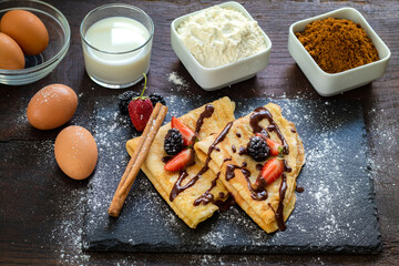 Top view of homemade crepes and ingredients.