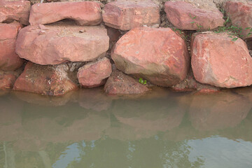 Brown stone with large patterns that are designed to be like nature by heavy machinery, beautifully crafted in a vast lakeside garden, perfect for relaxing and watching nature in summer and winter.