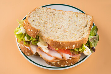 Sandwich of tomato, lettuce and smoked turkey