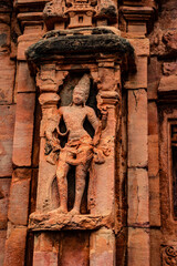 sculptures of hindu gods on facade of 7th century temple carved walls in Pattadakal