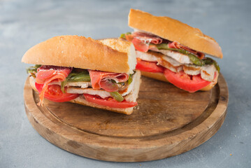 Sandwich Serranito typical in Andalusia with ham, green pepper and grilled pork loin