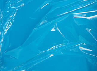 texture of a transparent stretching plastic film for packaging products on a blue background