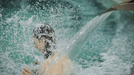 Closeup girl enjoying spa treatment in pool. Woman relaxing at luxury hotel