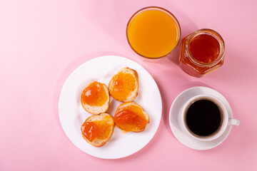 orange jam toasts and drink as breakfast concept
