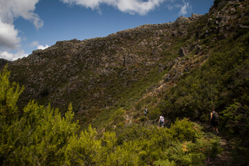 Hikers walking alongside mountain hills