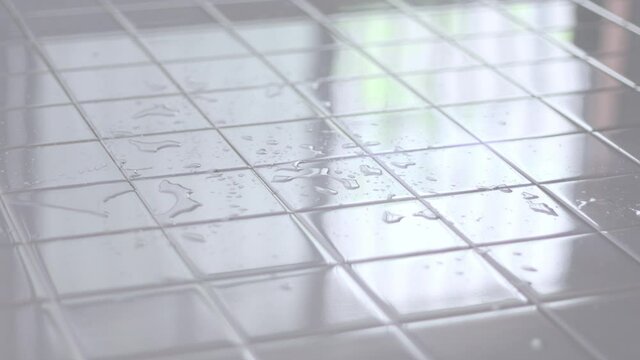 Water drops falling on the bathroom floor