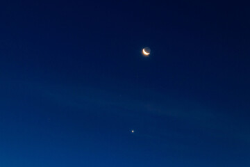 Crescent moon and stars in dark blue sky