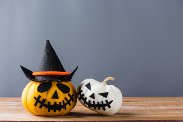 Funny Halloween day decoration party, closeup halloween pumpkin head jack o lantern smile scary on wooden and copy space, studio shot isolated gray background, Happy holiday concept