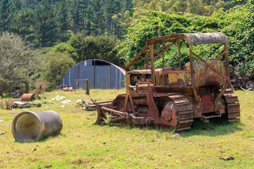 An old, abandoned bulldozer, rusting on a farm