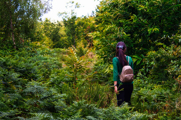 girl in the forest wearing a backpack 