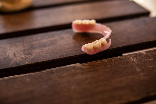 Flexible denture on a wooden table