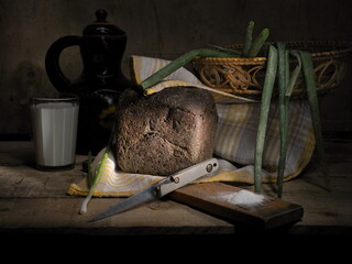 Homemade bread, milk and green onions. Still life.