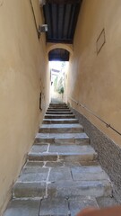 Decorated small alley in the centre of the historical town of Cortona, Arezzo, Italy.