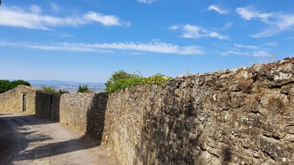 Street on the top of Cortona with the defensive walls on the right.