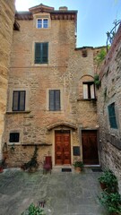 Fototapeta na wymiar Ancient buildings in the city centre of the beautiful Cortona, Italy.