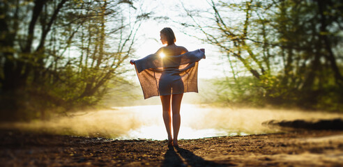 girl in the morning at the lake shore at sunrise