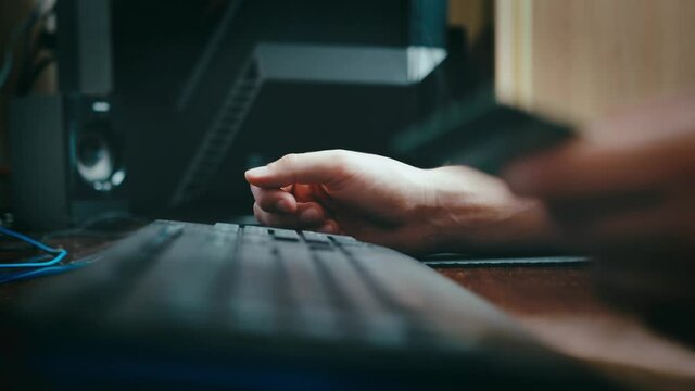 a cinematic picture of male hands and fingers filling out payment details. the programmer works from home. guy is shopping online. a man enters data from a credit card on a personal computer.
