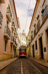 Naklejka na ściany i meble Lisbon tramway going through the old city