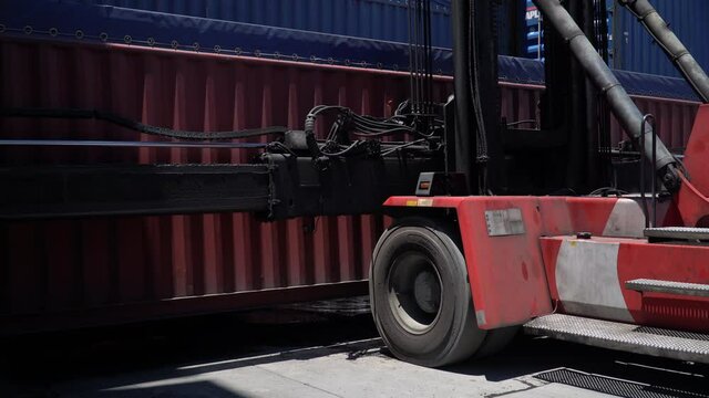 forklift  lifting up container in shipping yard