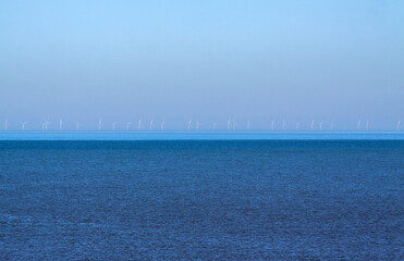 Off shore wind park near the coast of the Netherlands (Katwijk), barely visible in early morning light