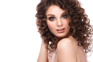 Portrait of beautiful brunette woman with a perfectly curly hair, and classic make-up.