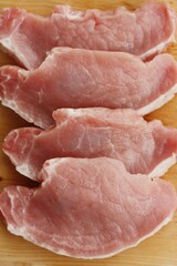 Fresh pork escalope on a wooden table
