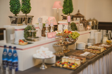 Delicious sweets on candy buffet. Wedding bakes on trays