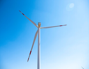 Fototapeta premium One windmill against a clear blue sky.