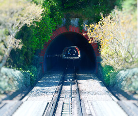 Cable car tracks entering mountain tunnel in Wellington, New Zealand
