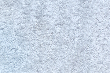 Close-up of soft white cotton towel material, top view. High resolution full frame textured background.