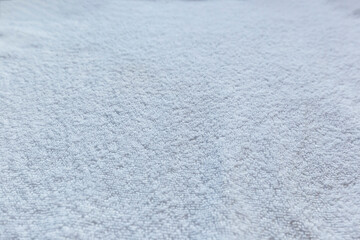 Close-up of soft white cotton towel material, viewed from the front.