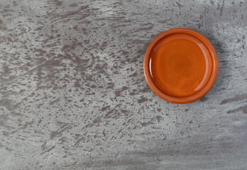 Bowl of light corn syrup on a gray background