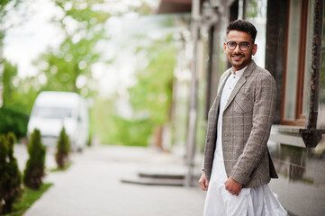 Stylish pakistani man wear in eyeglasses and jacket. - obrazy, fototapety, plakaty