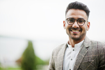 Stylish pakistani man wear in eyeglasses and jacket.