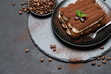 Classic tiramisu dessert on ceramic plate on concrete background