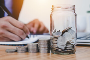 business accounting with saving money with coins in jug glass On the desk concept financial 