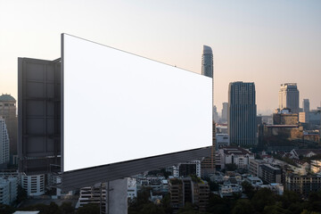 Blank white road billboard with Bangkok cityscape background at sunset. Street advertising poster, mock up, 3D rendering. Side view. The concept of marketing communication to promote or sell idea.