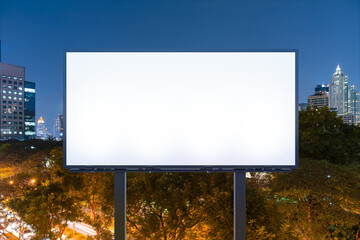 Blank white road billboard with Bangkok cityscape background at night time. Street advertising poster, mock up, 3D rendering. Front view. The concept of marketing communication to promote idea.