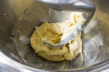 Close up for bread making process by using flour mixing machine.